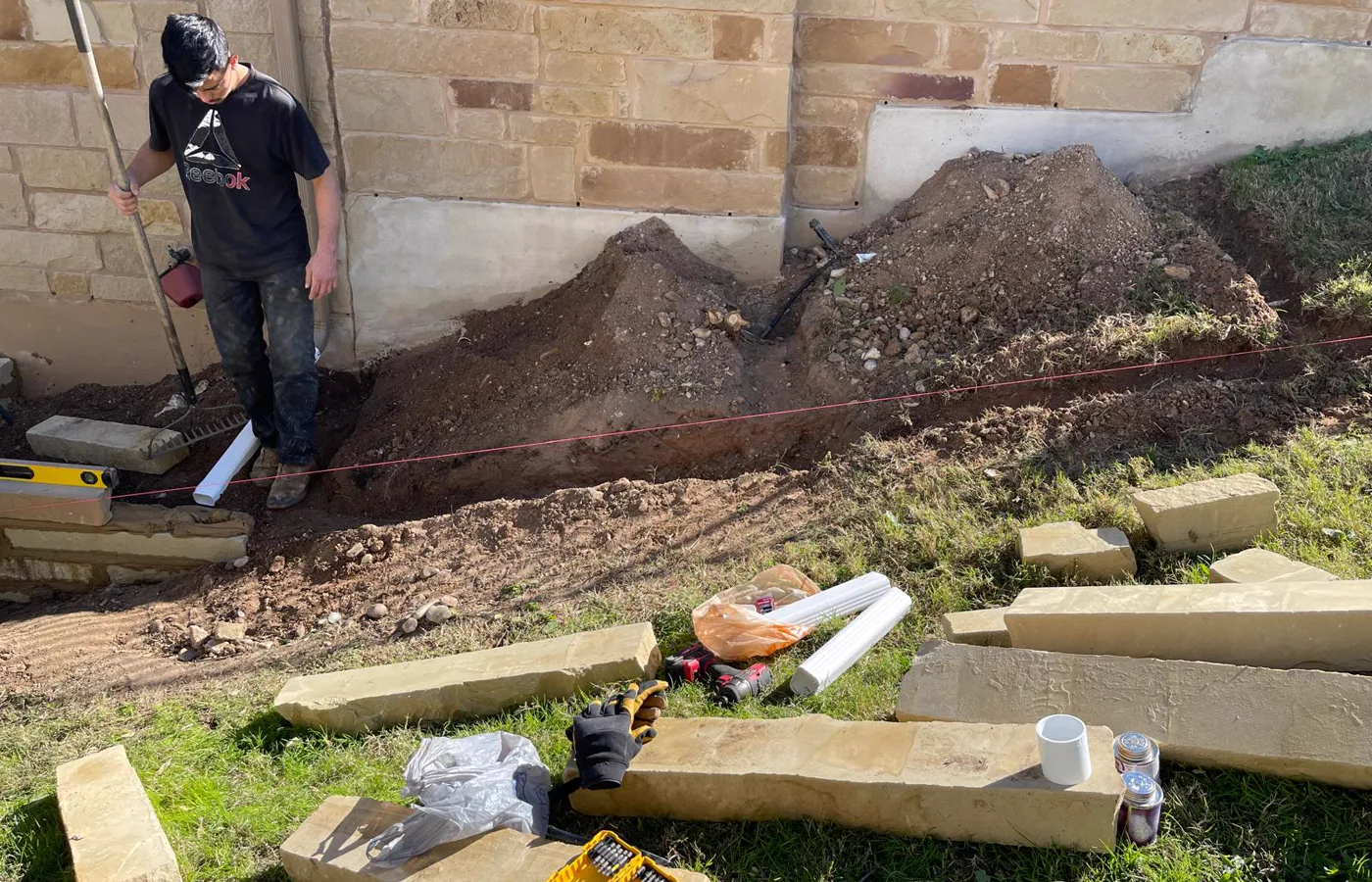 Drainage trench preparation beside a Cedar Park home